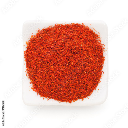 Photo: Paprika ground in a white bowl on white background. Paprika ground in a white bowl on white background.