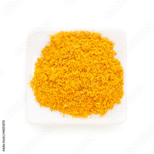 Photo: Curry ground (Madras Curry) in a white bowl on white background. Curry ground (Madras Curry) in a white bowl on white background.