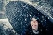 Photo: Young woman with umbrella in a blizzard Young woman with umbrella in a blizzard