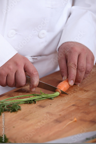 Photo: Man cutting carrots Man cutting carrots