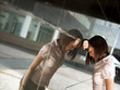 frustrated woman banging head against wall of office building