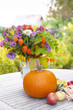 Gartentisch dekoriert mit Blumenvase, Obst und Gemüse