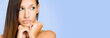 Large blue banner with portrait of a  pensive brunette beauty.
