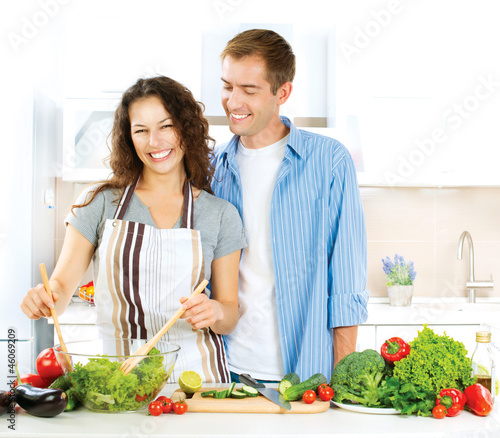 Photo: Happy Couple Cooking Together. Dieting. Healthy Food Happy Couple Cooking Together. Dieting. Healthy Food