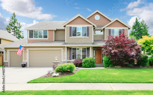 Photo: Beige large luxury house with summer landscape. Beige large luxury house with summer landscape.