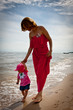 Mother with her baby  having fun on the beach
