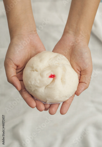 Photo: Hand giving a bun Hand giving a bun