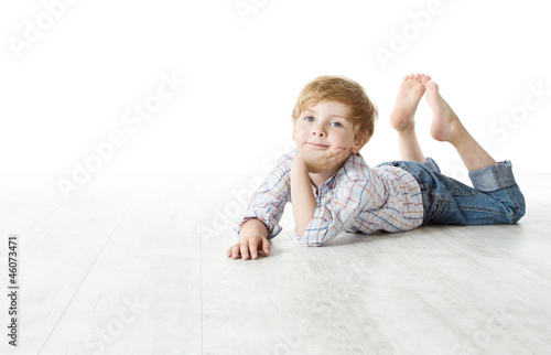 Photo: Child lying down on floor and looking at camera Child lying down on floor and looking at camera