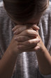Woman Folds Hands and Prays
