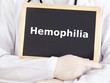 Doctor shows information on blackboard: hemophilia