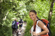 Photo: people with backpack doing trekking in wood people with backpack doing trekking in wood