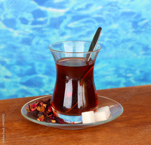 Photo: glass of Turkish tea on color background glass of Turkish tea on color background