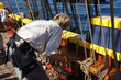 The crew sets the sails of the Lady Washington