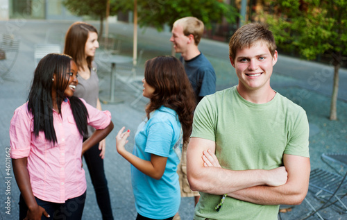 Photo: Young man smiling with friends Young man smiling with friends
