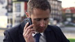 Businessman getting bad news on cellphone, slow motion shot at 2