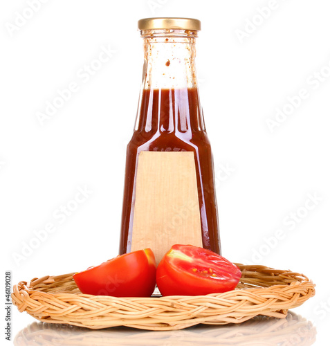 Photo: Tomato sauce in bottle on wicker mat isolated on white Tomato sauce in bottle on wicker mat isolated on white