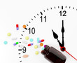 Clock and pills come out from a medicine bottle