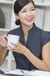 Chinese Asian Woman Businesswoman Drinking Tea or Coffee