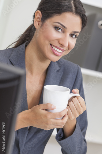 Photo: Woman Businesswoman Drinking Coffee in Office Woman Businesswoman Drinking Coffee in Office