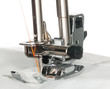 Photo: Metal foot of sewing machine on clothing Metal foot of sewing machine on clothing