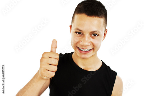 Photo: Portrait of a teenage boy with thumbs up on a white background Portrait of a teenage boy with thumbs up on a white background