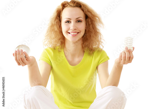 Photo: A woman with an energy-saving bulb meditating A woman with an energy-saving bulb meditating