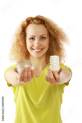 Photo: A young woman with an energy-saving bulb A young woman with an energy-saving bulb
