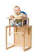 Baby sitting in highchair.