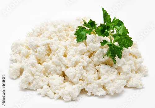 Photo: Heap of the fresh cottage cheese with parsley isolated Heap of the fresh cottage cheese with parsley isolated