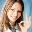 Smiling doctor with okay gesture