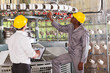 textile factory manager and worker checking yarn