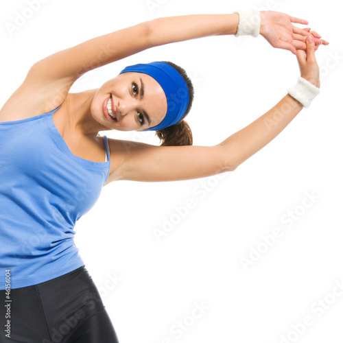 Photo: Cheerful young exercising woman, over white Cheerful young exercising woman, over white