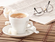 Photo: cup of coffee, sugar and newspaper closeup cup of coffee, sugar and newspaper closeup