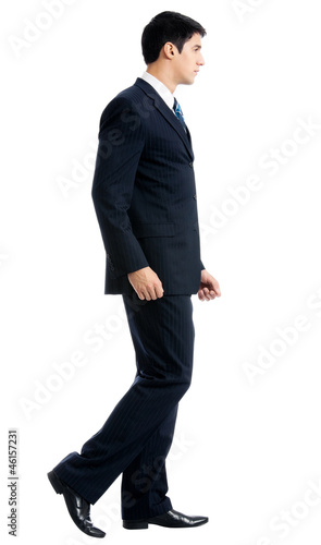 Photo: Full body of walking businessman, isolated Full body of walking businessman, isolated