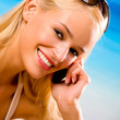 Young woman with cellphone on beach