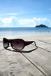 Sun glasses on wood over the blue sky