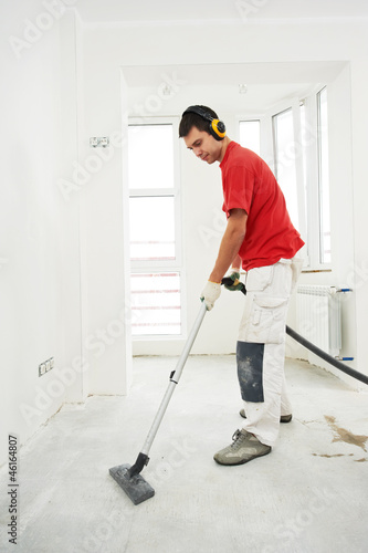 Photo: worker cleaning floor at home renovation worker cleaning floor at home renovation