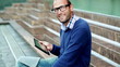 Portrait of young man with tablet  sitting, stairs, outdoors