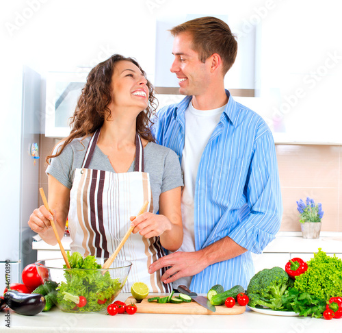 Photo: Happy Couple Cooking Together. Dieting. Healthy Food Happy Couple Cooking Together. Dieting. Healthy Food