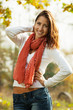 Photo: Smiling young woman outdoors on a sunny autumn day Smiling young woman outdoors on a sunny autumn day