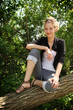 Teen sit on a tree