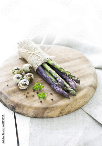 Photo: Asparagus and quail eggs on wooden board Asparagus and quail eggs on wooden board