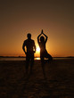 young businessman, businesswoman yoga asana sea shore