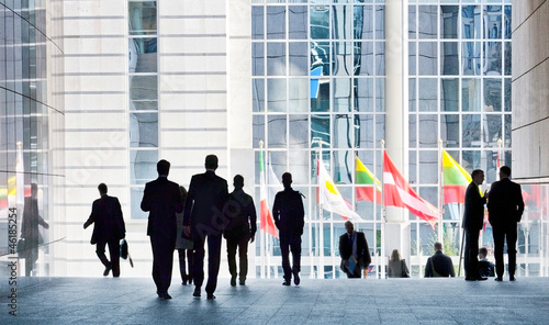 Photo: People walking against a light background. People walking against a light background.