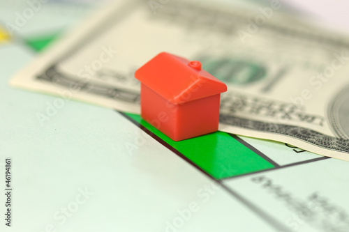 Photo: Monopoly hotel (house) on 100 dollar banknote Monopoly hotel (house) on 100 dollar banknote