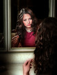 Portrait of gorgeous girl looking in mirror