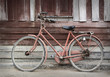 Old bicycle leaning against grungy barn
