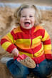 girl is playing in a sandbox