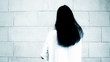 Mysterious woman with long black hair - horror concept