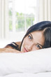 Photo: Portrait of young beautiful woman on white sheet Portrait of young beautiful woman on white sheet